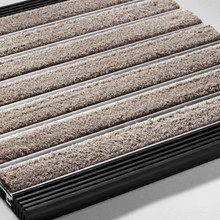 Close-up of a carpeted stair tread with a metal stair case.
